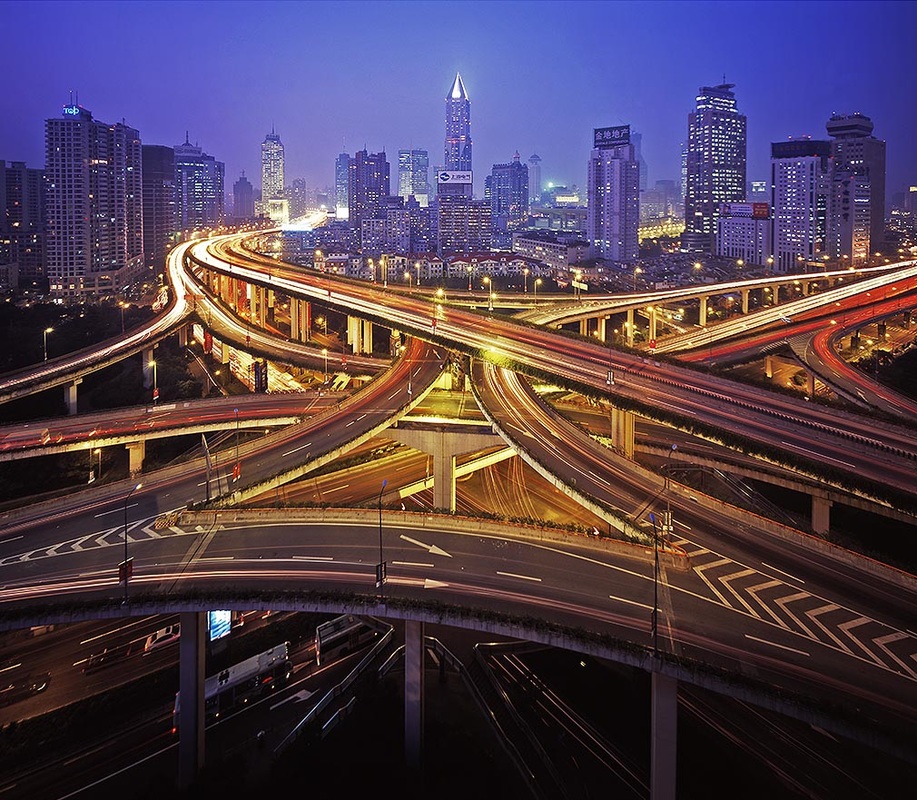 Elevated freeways crossing at night with headlight trails, Shanghai